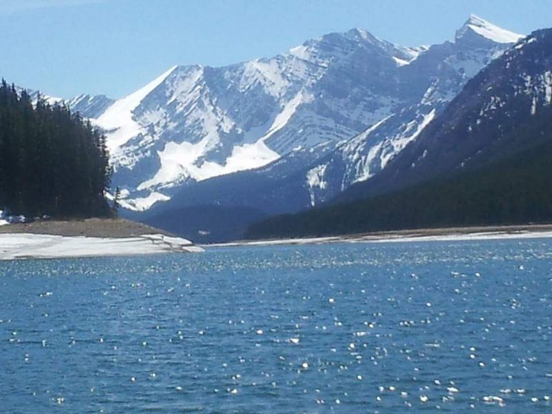 Blue water of Lower Kananaskis Lake below snowy peaks