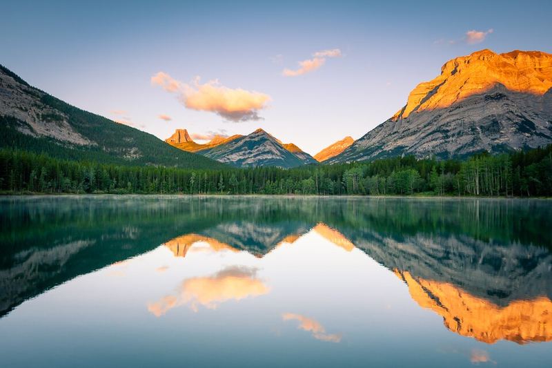 Sunrise peaks reflected in still Wedge Pond