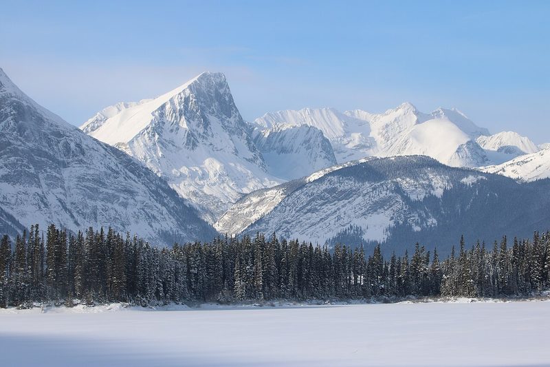 Mountain lake below snowy peaks
