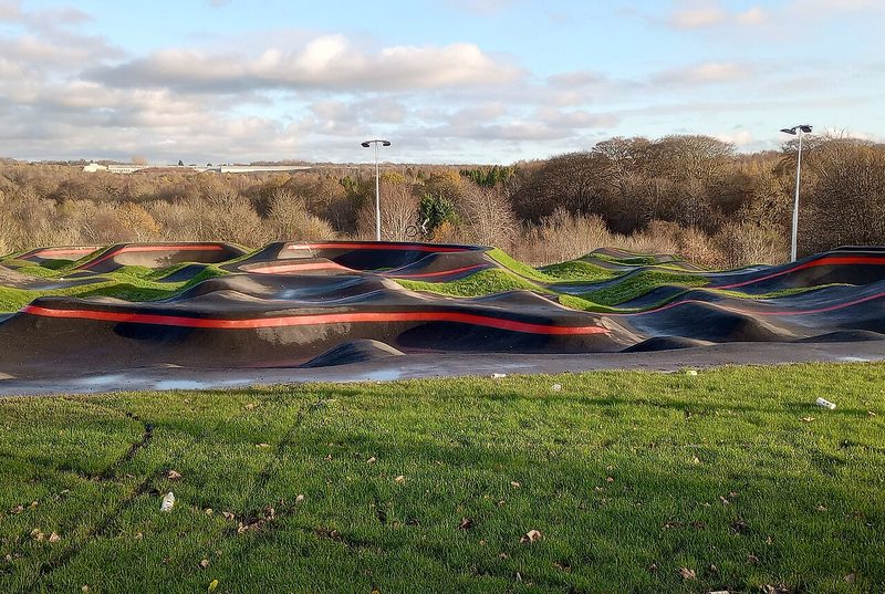 Empty asphalt bike pump track with berms