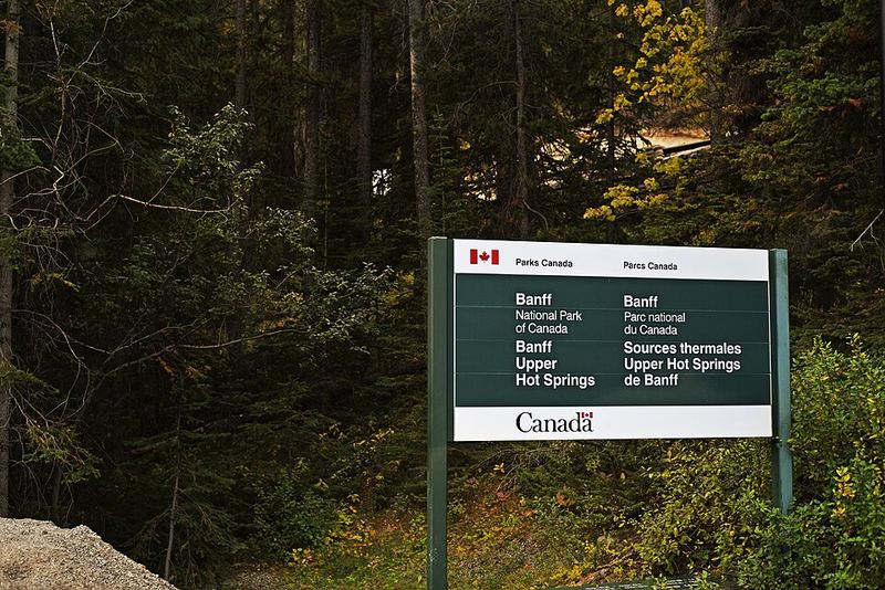 The Parks Canada sign for Banff Upper Hot Springs among trees